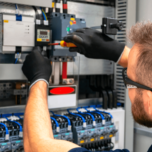Industrial electricians working in a modern factory